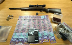 A firearm, ammunition, drugs, cash, and multiple stolen items have been seized by Police.