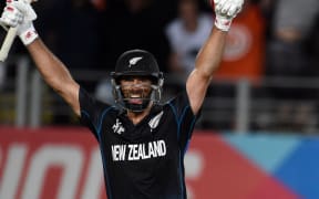 Grant Elliott raises his arms in triumph after hitting the winning runs with a six