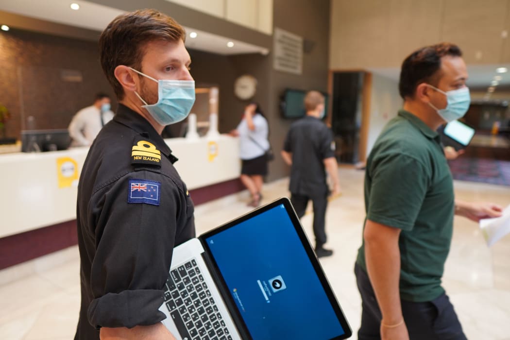 At the Waipuna Hotel managed isolation facility lieutenant Sam Wilson and Wellbeing Coordinator, Charlie, monitor returnees arriving, and take any extra requests they have.
