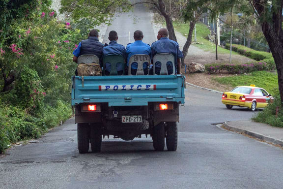 Police commute on a road as the close streets leading to Parliament house in Port Moresby on May 28, 2019. Papua New Guinea Prime Minister Peter O'Neill stalled his announced resignation and took legal action to prevent a vote of no confidence on May 28, deepening the country's political crisis. (Photo by Ness Kerton / AFP)
