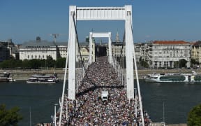 People gather for the 30th Budapest Pride March in Budapest, Hungary, on July 28. The Pride march, which the national assembly bans earlier this year citing child protection, is organized regardless by the local government of Budapest, with over 70 MEPs expected to be in attendance. (Photo by Balint Szentgallay/NurPhoto) (Photo by Balint Szentgallay / NurPhoto via AFP)