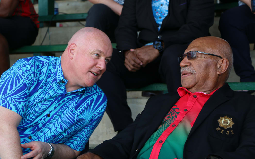 Prime Minister Christopher Luxon watching a Sevens game between the NZDF and Fiji DF, with Fiji's PM Sitiveni Rabuka.