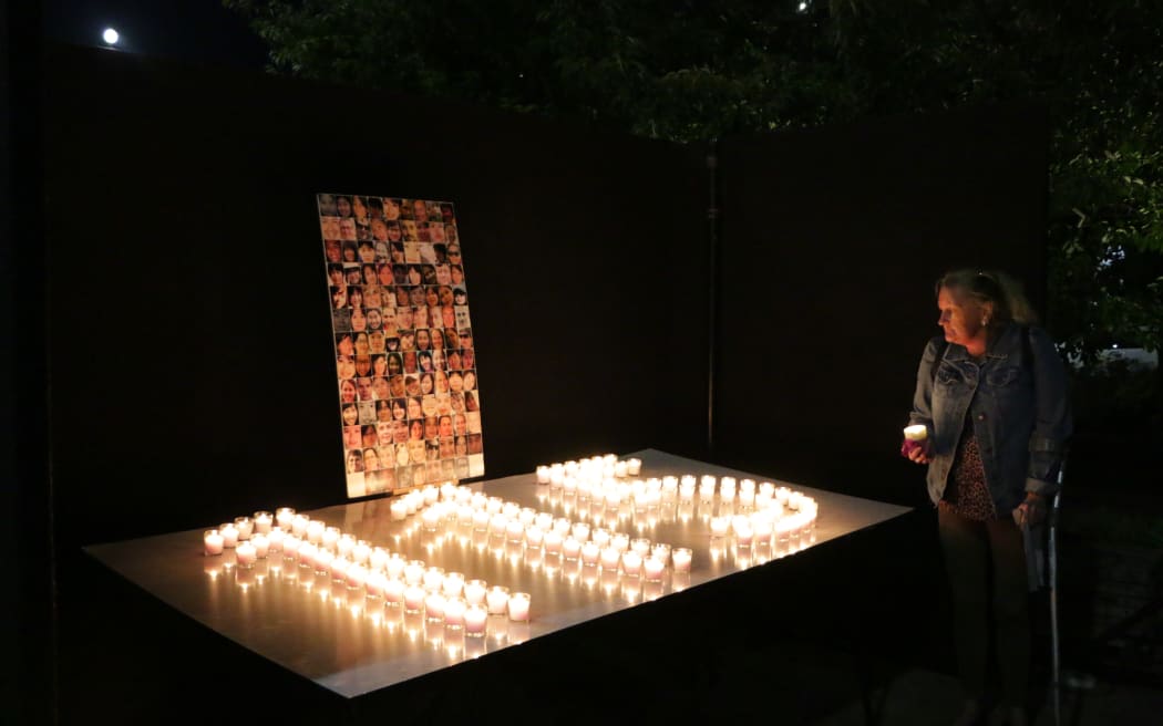 Julie Abraham has a quiet moment of reflection at the vigil.