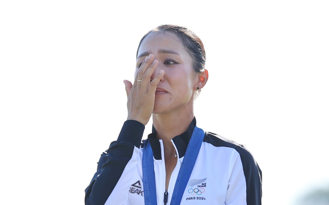 Lydia Ko (NZL) shows her emotion as she stands on the podium with her Gold medal after winning the Women's Individual Stroke Play Golf at Paris 2024.