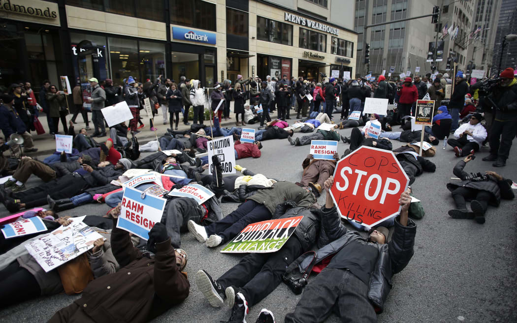 Demonstrators continue to protest the fatal police shooting of Laquan McDonald as they attempt to disrupt holiday shoppers along Chicago's Michigan Avenue.