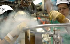 Engineers adding liquid helium to the system to keep antimatter at minus 270 celcius, near to the lowest possible temperature, absolute zero