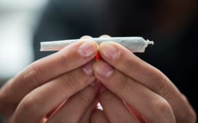 drug use, substance abuse, addiction and people concept - close up of addict hands with marijuana joint