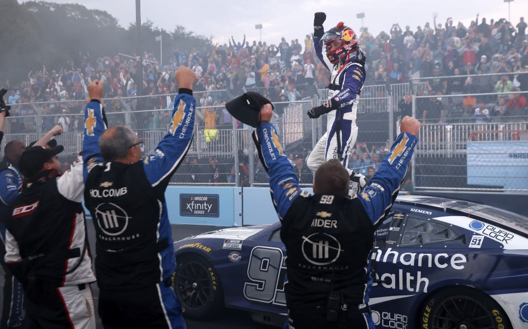 Shane van Gisbergen celebrates celebrates after winning the NASCAR Cup Series Grant Park 220 at the Chicago Street Course in downtown Chicago, Illinois.