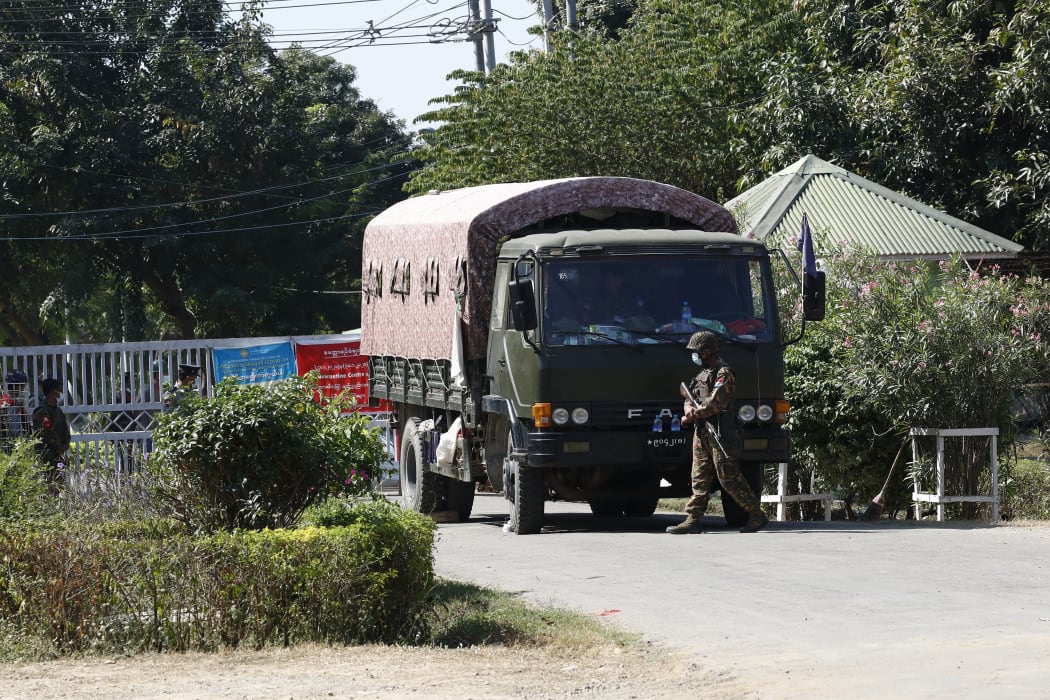 Military trucks loaded with soldiers take security at the entrance of Si Bin Guesthouse where members of parliament stay in Naypyidaw in Myanmar