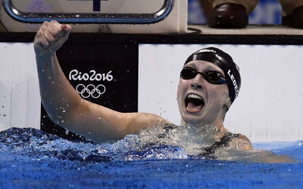 US swimmer Katie Ledecky celebrates breaking her own world record for the women's 400m freestyle at the Rio 2016 Olympic Games on 8 August 2016 (NZT).