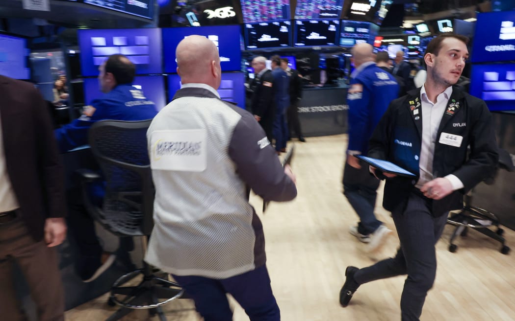 Traders work on the floor of the New York Stock Exchange in New York City, on April 7, 2025. Wall Street stocks opened sharply lower Monday, joining a global selloff on worries that a trade war induced by US President Donald Trump's tariffs will spark a global economic slowdown. (Photo by TIMOTHY A. CLARY / AFP)