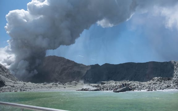 This handout photograph courtesy of Michael Schade shows the volcano on New Zealand's White Island spewing steam and ash minutes following an eruption on December 9, 2019.