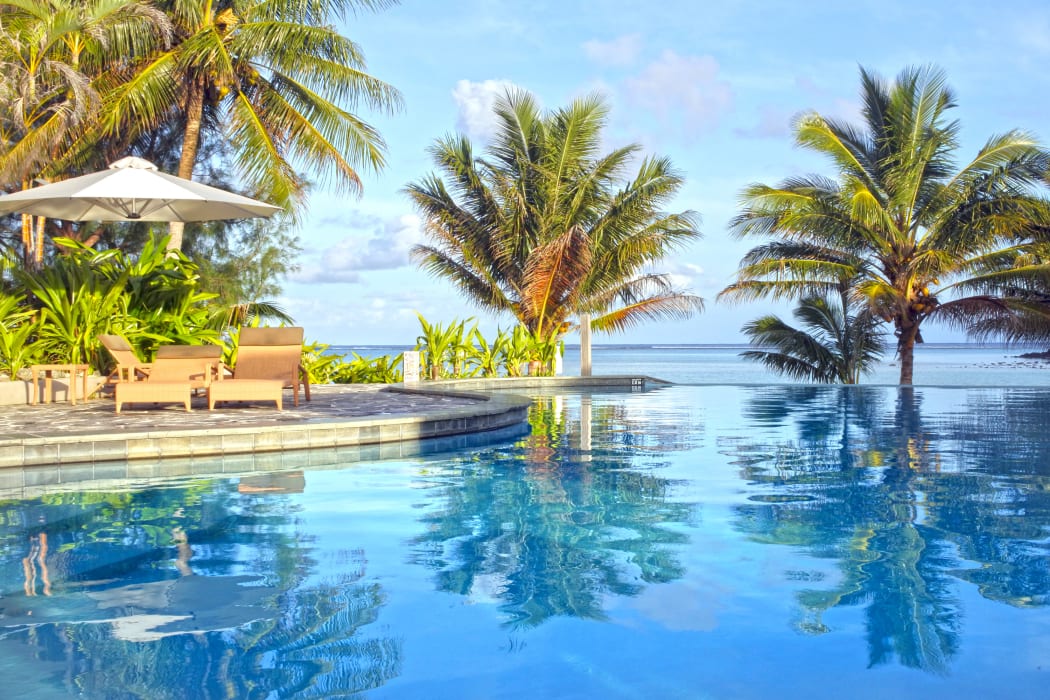 Empty swimming pool in a tropical island resort at sunset in Rarotonga , Cook Islands.