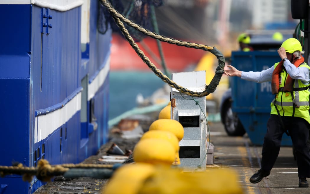 NIWA's Tangaroa moves 50m down the wharf with three Greenpeace protesters on board.