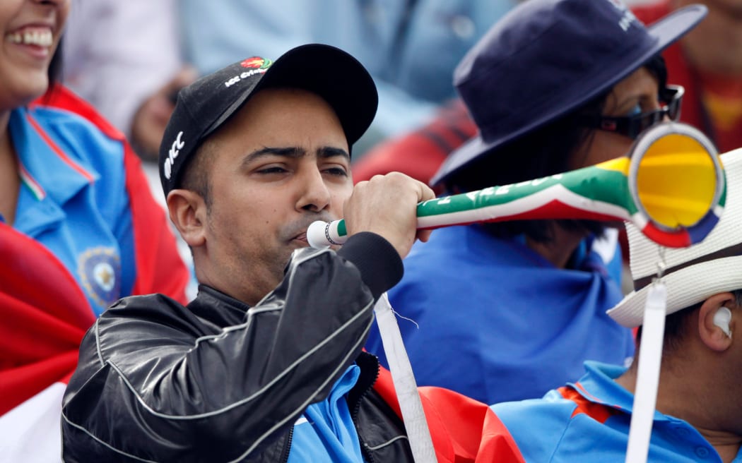A fan blows a vuvuzela