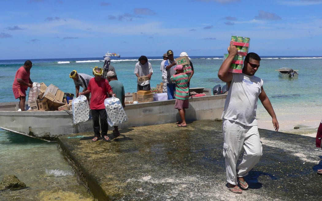 Undated photo shows villagers unloading goods from a barge in Nukunonu atoll, Tokelau. Tokelau has no airport or port and all passengers and goods have to be brought ashore on the three atolls by barges through a gap in the surrounding reef. The only contact with the outside world is through a fortnightly shipping service from Apia, 500 km (310 miles) to the south.