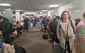 Long lines of people at Auckland Airport trying to rebook their flights because of weather disruption on 2 October, 2023.