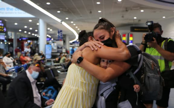 A reunited family at Auckland International Airport today, with a grandmother meeting her grandchild for the first time.