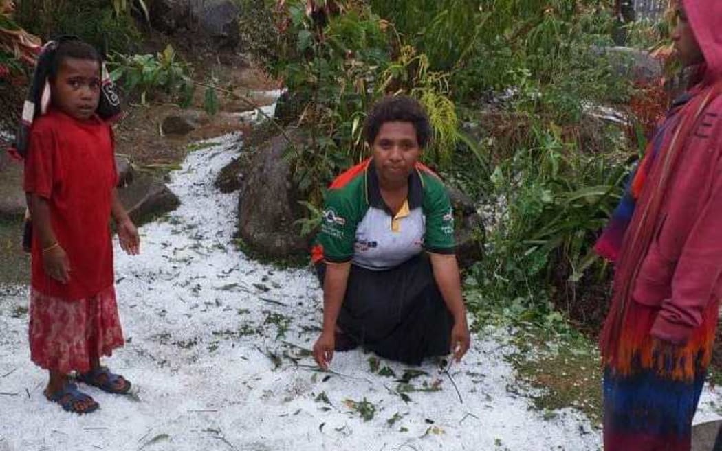 Villagers inspecting the fallen hail.