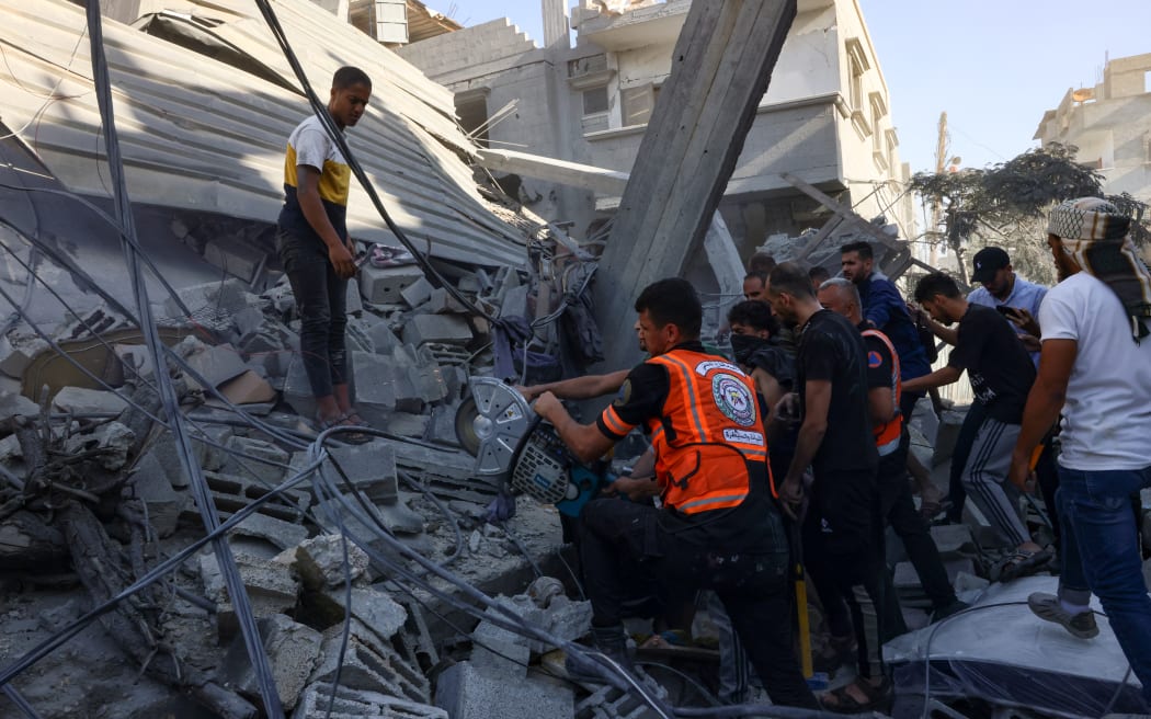 Rescuers use a wheel saw to recover people from under the rubble of a collapsed building following an Israeli air strike on Rafah in southern Gaza Strip on October 26, 2023, amid ongoing battles between Israel and the Palestinian Hamas movement.