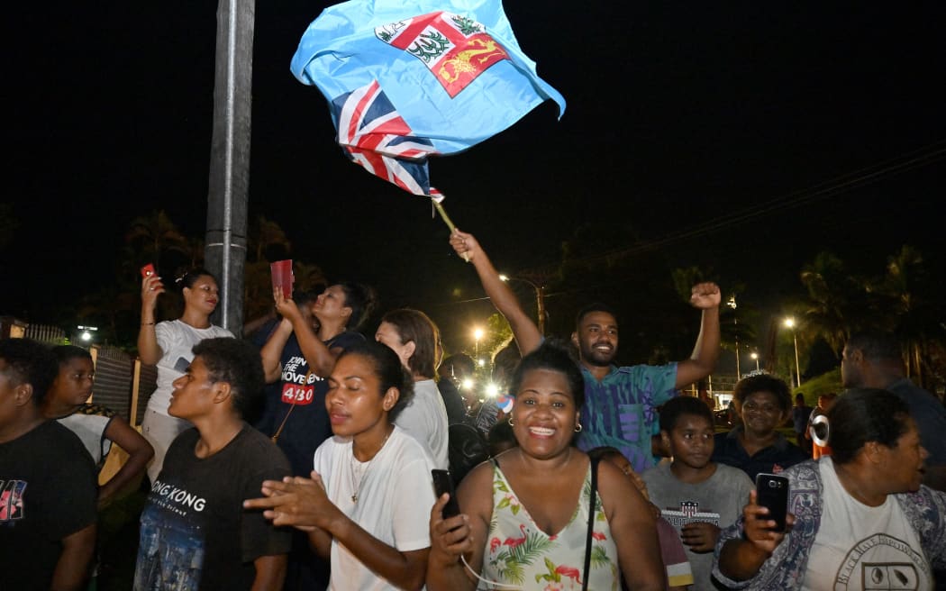 Workers and supporters of People's Alliance Party celebrate after securing a support of the Social Democratic Liberal Party to form a new government.