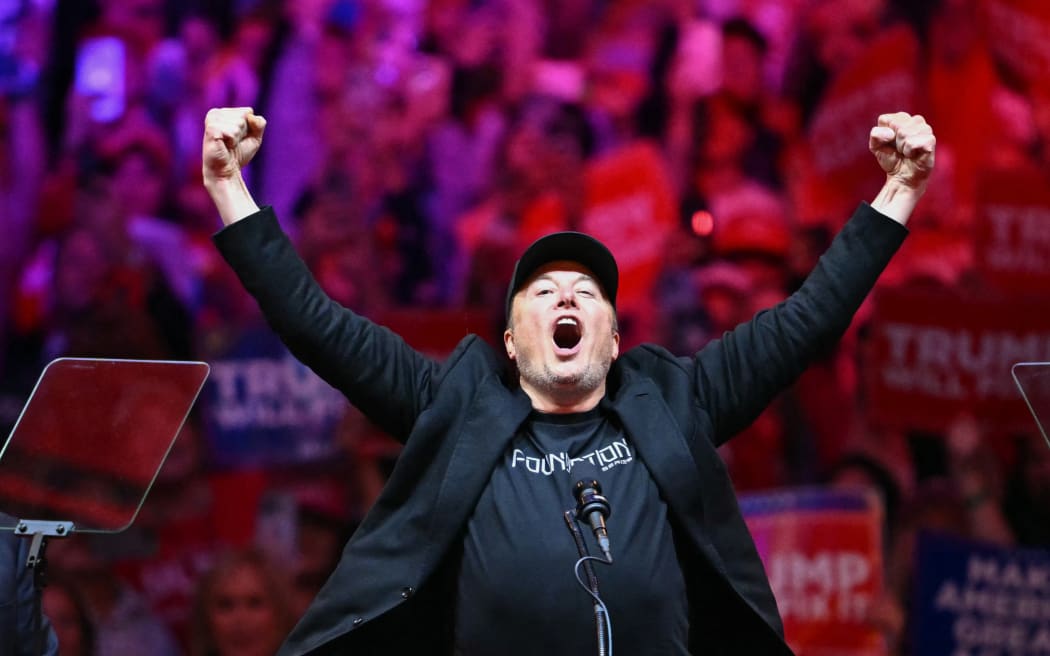 Tesla and SpaceX CEO Elon Musk gestures as he steps on stage during a rally for former US President and Republican presidential candidate Donald Trump at Madison Square Garden in New York, October 27, 2024. (Photo by ANGELA WEISS / AFP)
