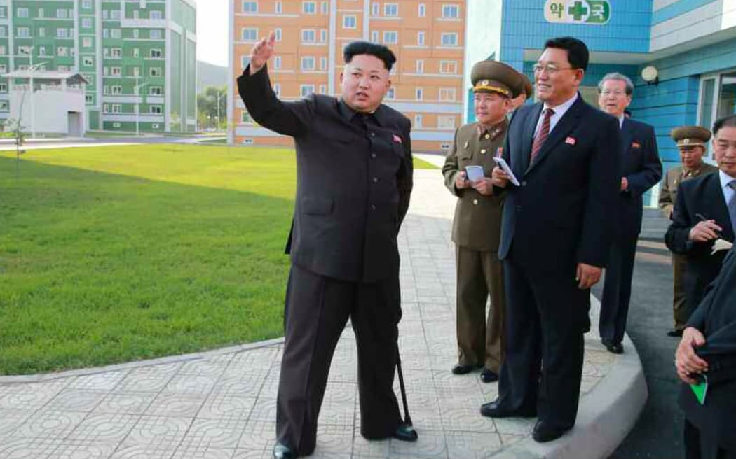 Kim Jong-Un, left, on a tour of new housing complex in Pyongyang.
