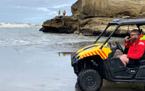Emergency services, including the Coastguard are searching for a missing swimmer at Karioatahi Beach in January 2024.
