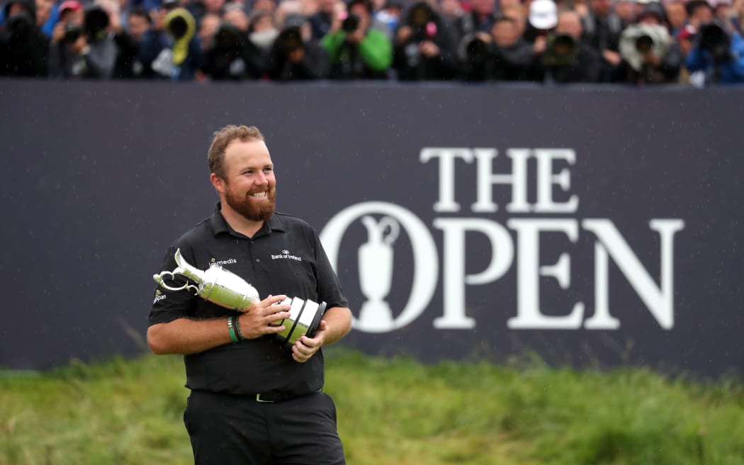 Ireland's Shane Lowry celebrates with the Claret Jug trophy after winning the 2019 British Open Championship at the Royal Portrush Golf Club.