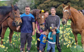 Reif Cotter (left), his three young children, and his wife Holly Te Ngahue.