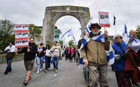 People take part in a pro-Israel rally in Christchurch on October 22, 2023. Thousands of people, both Israeli and Palestinians have died since October 7, 2023, after Palestinian Hamas militants based in the Gaza Strip, entered southern Israel in a surprise attack leading Israel to declare war on Hamas in Gaza the following day. (Photo by Sanka Vidanagama / AFP)