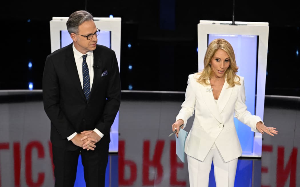 Moderators and CNN anchors Jake Tapper (L) and Dana Bash speak ahead of the fifth Republican presidential primary debate between Florida Governor Ron DeSantis and former US Ambassador to the UN Nikki Haley at Drake University in Des Moines, Iowa, on 10 January, 2024.