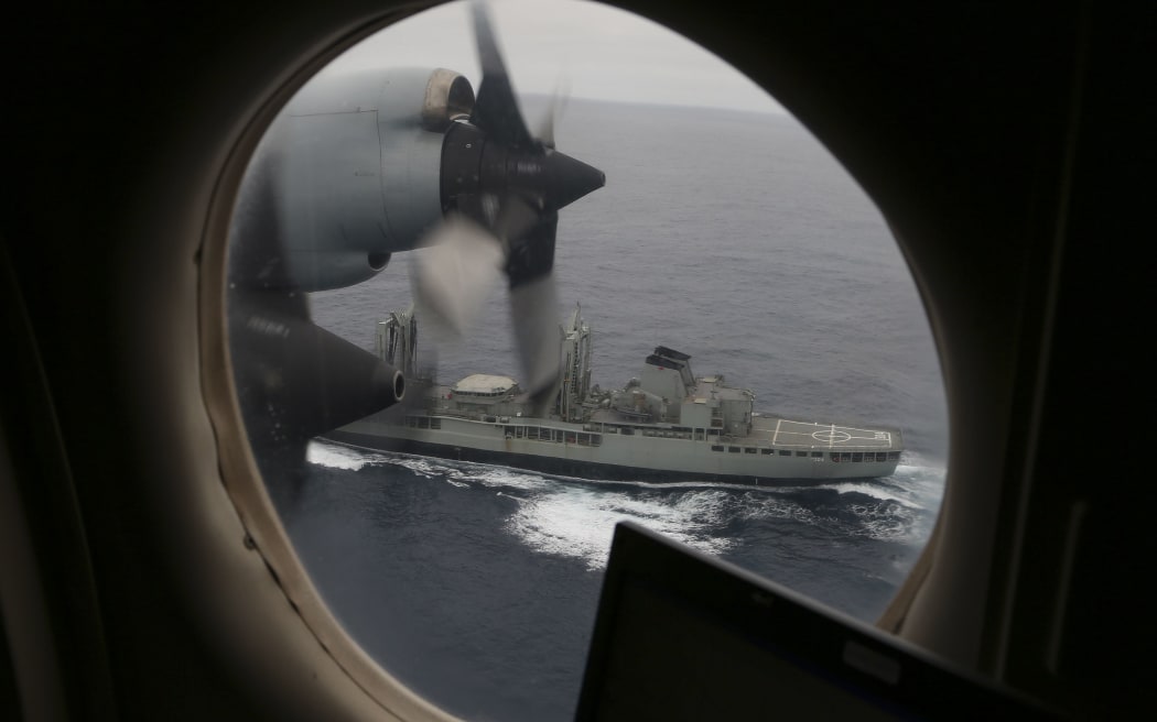 An Australian Air Force Orion flies past HMAS Success as they search the southern Indian Ocean.