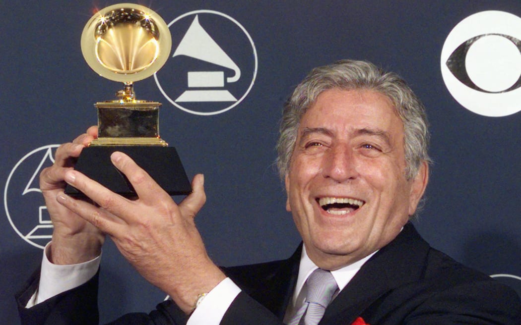 Singer Tony Bennett holds his Grammy Award for Best Traditional Pop Vocal Performance for 'Tony Bennett on Holiday', on 25 February, 1998, in New York.