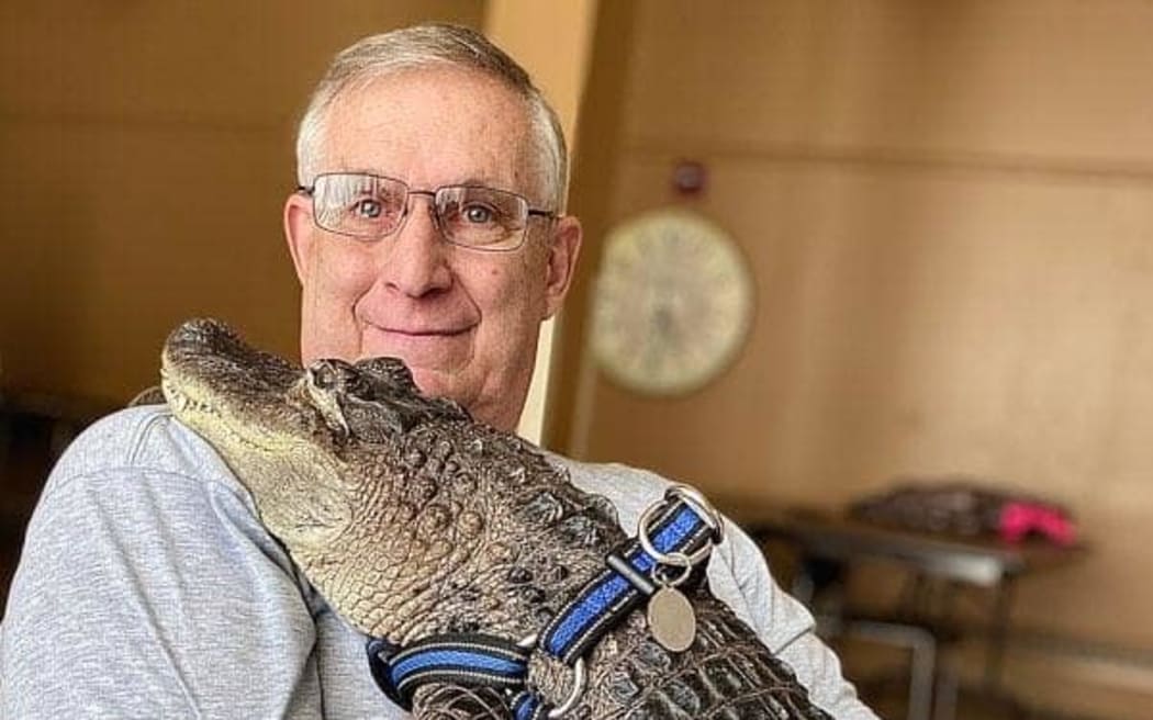 Joseph Henney and his emotional support alligator Wally.