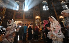 Orthodox worshippers attend an Easter service in Saint Michael's Golden-domes Cathedral in Kyiv on Sunday 20 April, 2025, amid the war in Ukraine, and accusations from both Russia and Ukraine of breaking a one-day ceasefire.