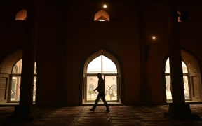 Kashmiri muslim walks by a window during the Friday prayer in Jamia Masjid in downtown Srinagar on November 25, 2016. 
TAUSEEF MUSTAFA / AFP