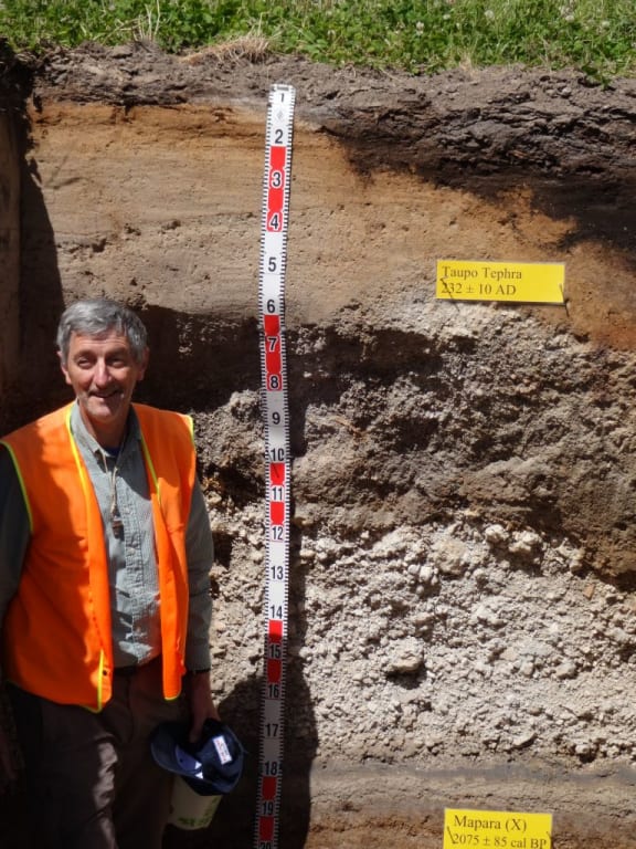 In the soil pit: Waikato University geoscientist David Lowe leads a field excursion to explore the layered deposits from the Taupo eruption.