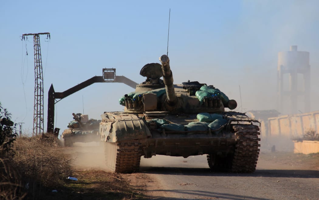 Syrian government forces' tanks drive in the village of Tal Jabin, north of the embattled city of Aleppo, as they advanced to break a three-year rebel siege of two government-held Shiite villages, Nubol and Zahraa, and take control of parts of the supply route on February 3, 2016.
