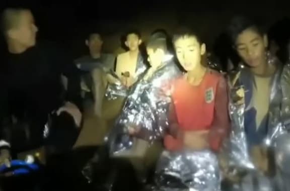 The boys can be seen introducing themselves next to a diver in a wetsuit.