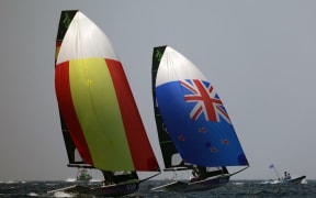 Crews from Spain and New-Zealand compete in the medal race of the men’s 49er skiff event during the Paris 2024 Olympic Games sailing competition at the Roucas-Blanc Marina in Marseille on August 2, 2024. (Photo by Clement MAHOUDEAU / AFP)