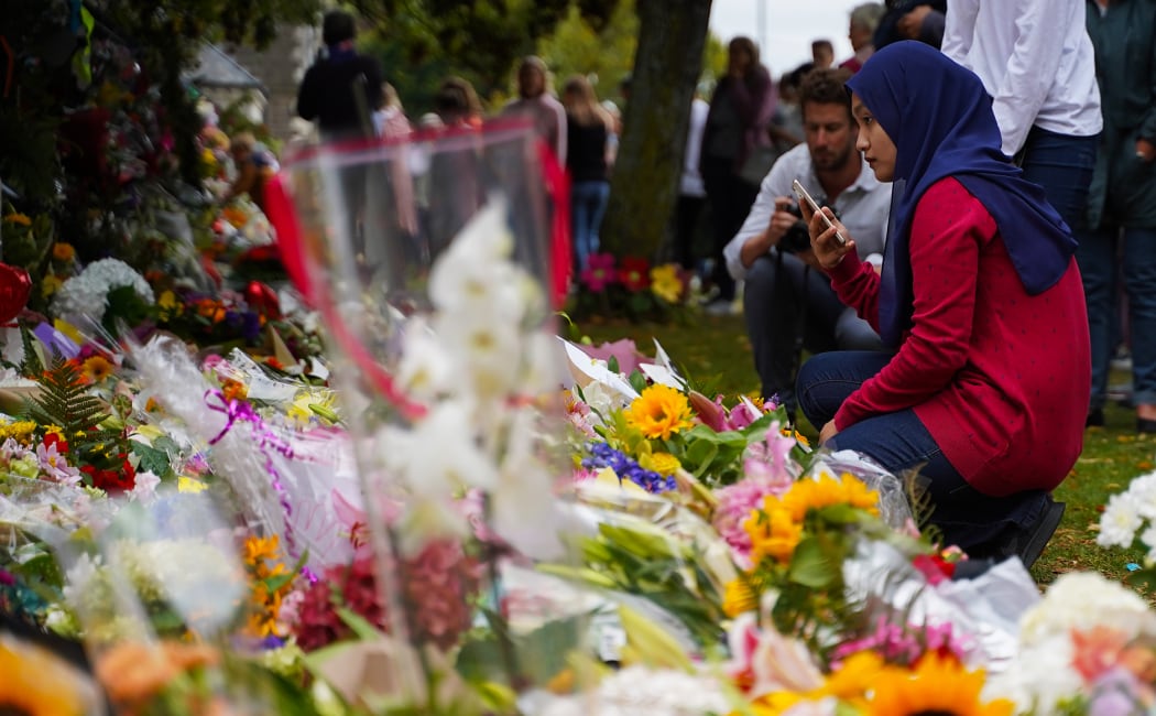 People laying flowers in Christchurch after the mosques shootings.