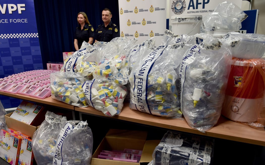 Australian Border Police with the crystal meth found concealed in packaging.
