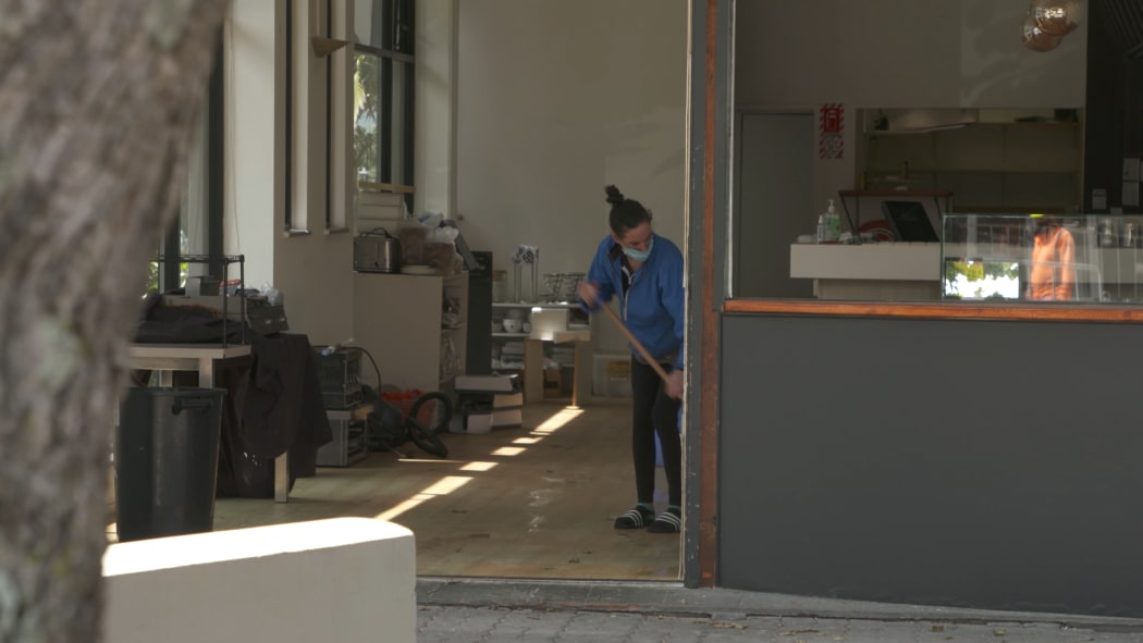 Ragazzi Cafe manager Hayley Isted sweeps the Takapuna cafe which is shutting down.