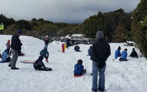Families enjoy the snow at Egmont National Park below Mt Taranaki.