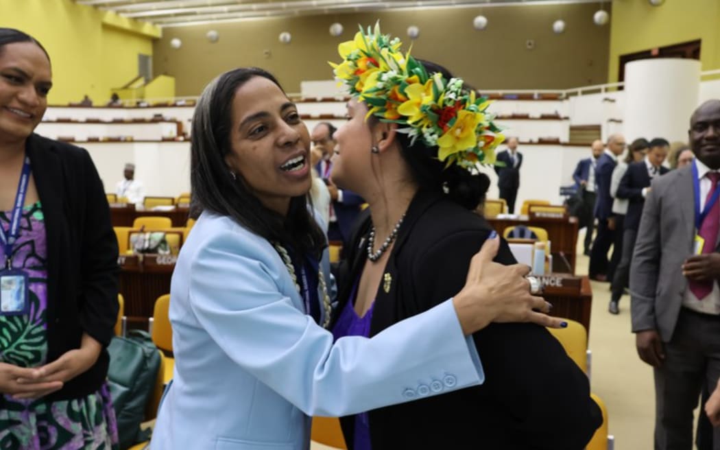 International Seabed Authority secretary-general elect, Leticia Carvalho [left] of Brazil, is congratulated by a member of the Cook Islands delegation following her election on Aug. 2, 2024 in Kingston, Jamaica.