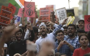Students and demonstrators hold placards and shout slogans during a protest against India's new citizenship law in Chennai.