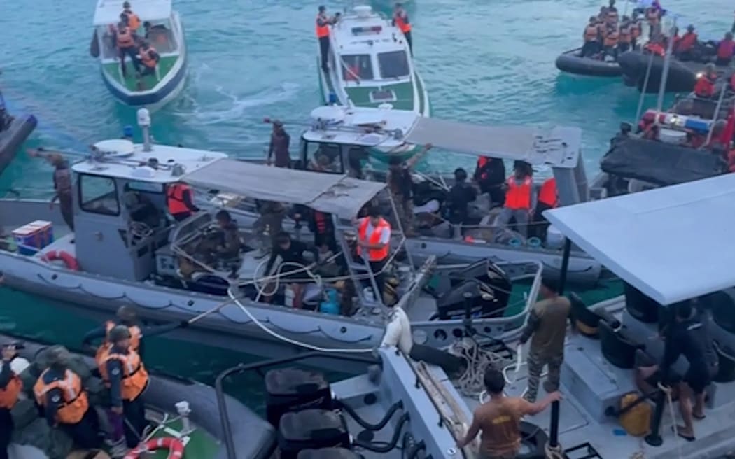 This screengrab taken from a handout video filmed on June 17, 2024 and released by Armed Forces of the Philippines-Public Affairs Office (AFP-PAO) on June 19 shows Chinese coast guard personnel (L,R) aboard their inflatable boats blocking Philippine navy boats (C) during a confrontation at the Second Thomas Shoal in the South China Sea. The Philippine military said on June 19, the Chinese coast guard rammed and boarded Filipino navy boats in a violent confrontation in the South China Sea this week in which a Filipino sailor lost a thumb. China defended its actions, with its foreign ministry saying that "no direct measures" were taken against Filipino personnel. (Photo by ARMED FORCES OF THE PHILIPPINES-PUBLIC AFFAIRS OFFICE / AFP) / RESTRICTED TO EDITORIAL USE - MANDATORY CREDIT "AFP PHOTO /ARMED FORCES OF THE PHILIPPINES-PUBLIC AFFAIRS OFFICE" - NO MARKETING NO ADVERTISING CAMPAIGNS - DISTRIBUTED AS A SERVICE TO CLIENTS