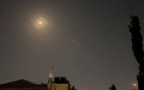 This video grab from AFPTV taken on April 14, 2024 shows explosions lighting up Jerusalem sky during Iranian attack on Israel. Iran's Revolutionary Guards confirmed early April 14, 2024 that a drone and missile attack was under way against Israel in retaliation for a deadly April 1 drone strike on its Damascus consulate. (Photo by AFPTV / AFP)