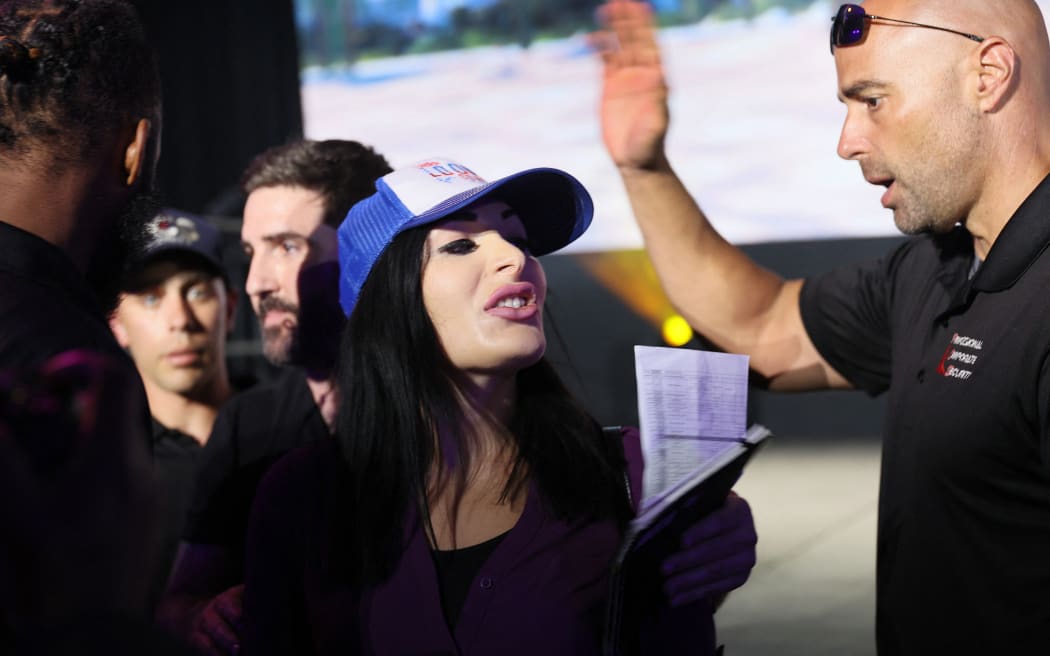 MIAMI, FLORIDA - JUNE 04: Laura Loomer is escorted out after interrupting Jack Dorsey creator, co-founder, and Chairman of Twitter and co-founder & CEO of Square as he spoke on stage at the Bitcoin 2021 Convention, a crypto-currency conference held at the Mana Convention Center in Wynwood on June 04, 2021 in Miami, Florida. The crypto conference is expected to draw 50,000 people and runs from Friday, June 4 through June 6th.   Joe Raedle/Getty Images/AFP (Photo by JOE RAEDLE / GETTY IMAGES NORTH AMERICA / Getty Images via AFP)